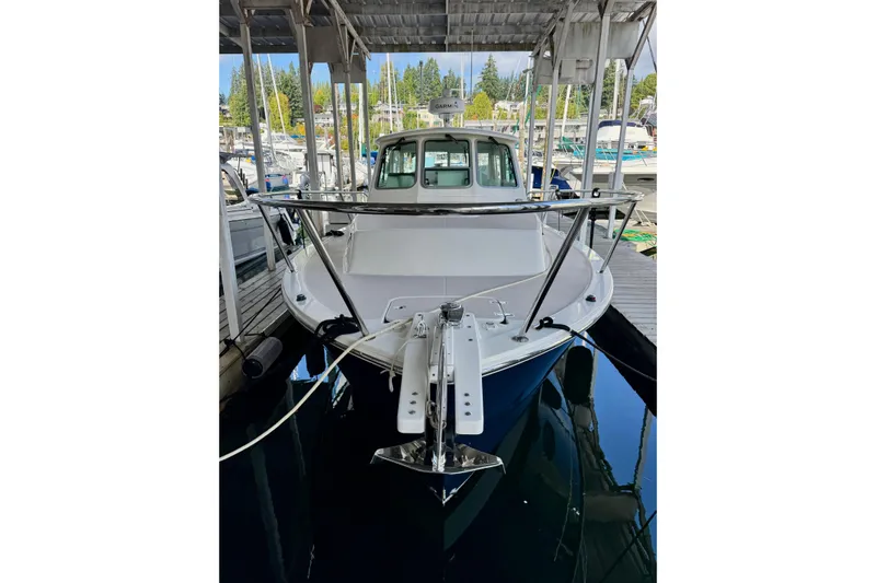 Tui Yacht Photos Pics 2005 Back Cove 29 boat docked in a marina, front view.