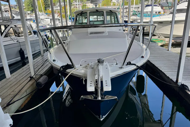 Tui Yacht Photos Pics 2005 Back Cove 29 boat docked in a marina, surrounded by other vessels.