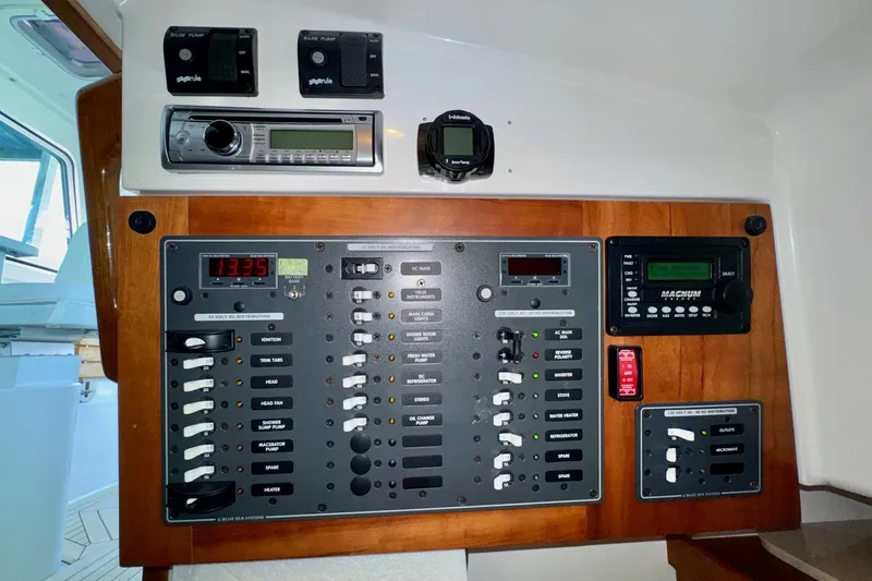 Tui Yacht Photos Pics Control panel of a 2005 Back Cove 29 boat with various switches and displays.