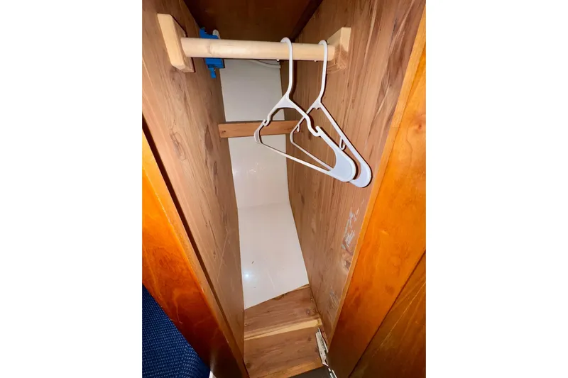Tui Yacht Photos Pics Wooden closet interior with hangers in a 2005 Back Cove 29 boat.