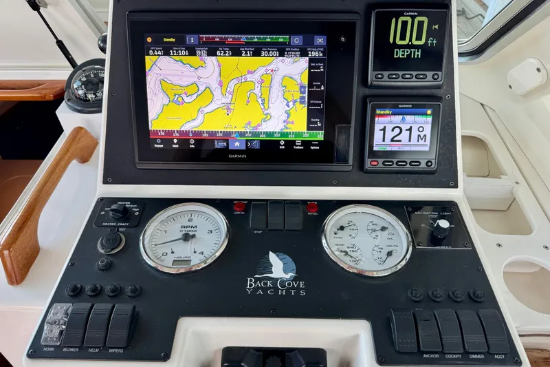 Tui Yacht Photos Pics Control panel of a 2005 Back Cove 29 yacht with navigation and depth displays.