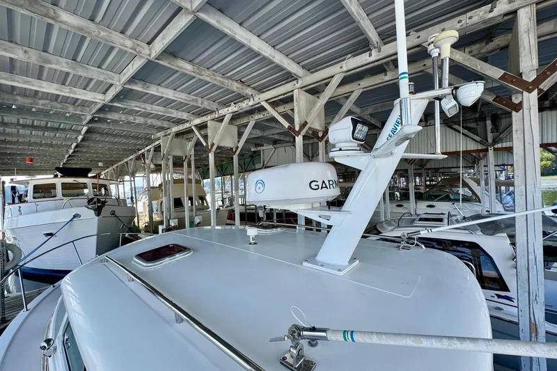 Tui Yacht Photos Pics 2005 Back Cove 29 boat docked under a covered marina.