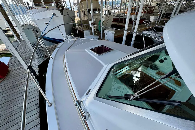 Tui Yacht Photos Pics 2005 Back Cove 29 boat docked in a marina, showcasing sleek design and spacious deck.