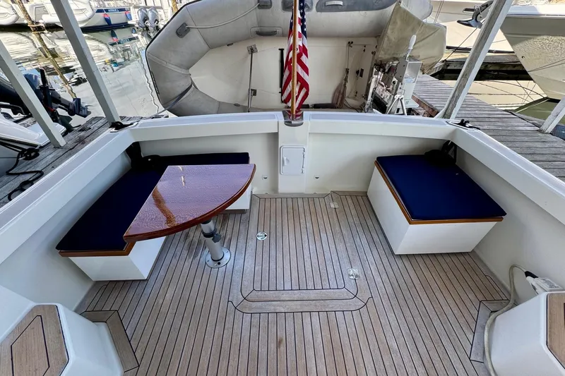 Tui Yacht Photos Pics 2005 Back Cove 29 boat interior with wooden deck, seating, and table.