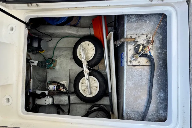 Tui Yacht Photos Pics Storage compartment of a 2005 Back Cove 29 boat with wheels and equipment.