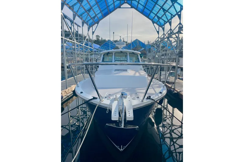 Tui Yacht Photos Pics 2005 Back Cove 29 boat docked under blue canopy.