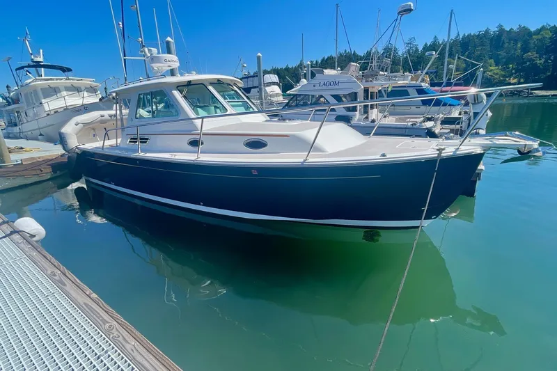 Tui Yacht Photos Pics 2005 Back Cove 29 boat docked in a marina, surrounded by other vessels.
