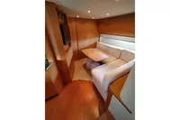 Luxurious interior of 2010 Pershing 56 yacht with cozy seating and wooden finishes.