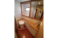 Luxurious bathroom in 2010 Pershing 56 yacht with modern fixtures and wooden accents.