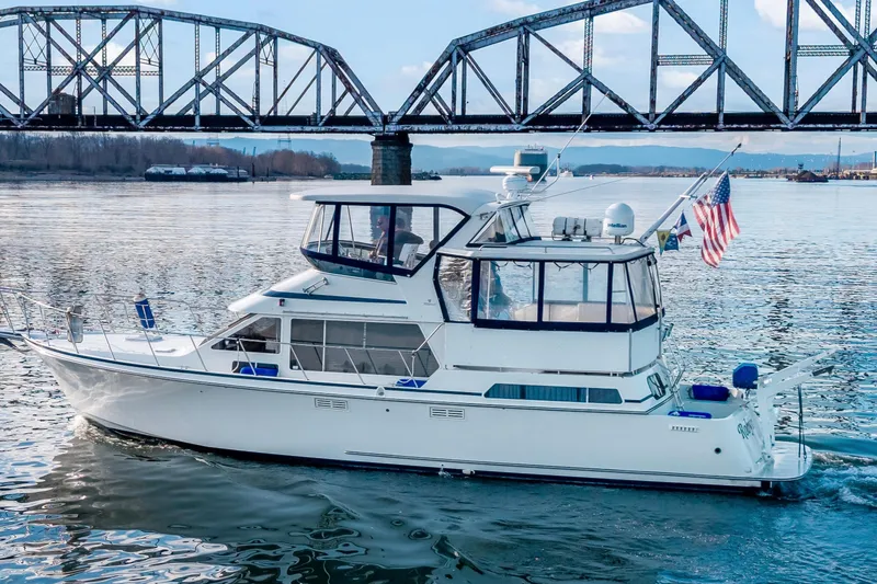  Yacht Photos Pics 1994 Tollycraft 45 Cockpit Motor Yacht cruising under a bridge on a calm river.