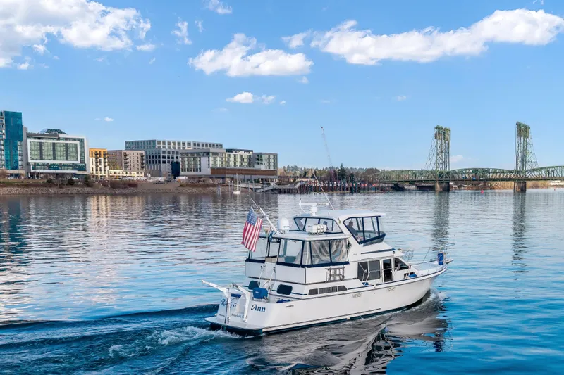  Yacht Photos Pics 1994 Tollycraft 45 Cockpit Motor Yacht cruising near city waterfront and bridge.