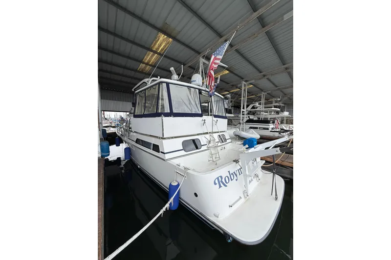  Yacht Photos Pics 1994 Tollycraft 45 Cockpit Motor Yacht docked in a covered marina.