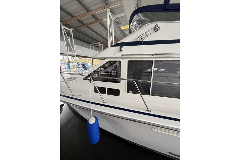  Yacht Photos Pics 1994 Tollycraft 45 Cockpit Motor Yacht docked in a covered marina.