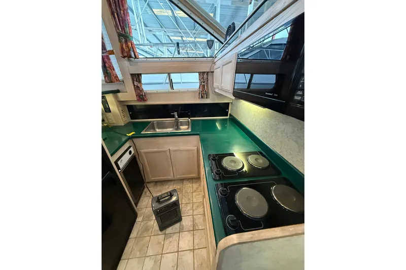  Yacht Photos Pics 1994 Tollycraft 45 Cockpit Motor Yacht kitchen with green countertops and modern appliances.