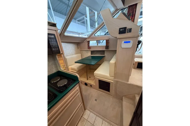  Yacht Photos Pics 1994 Tollycraft 45 Cockpit Motor Yacht interior with dining area and kitchen.