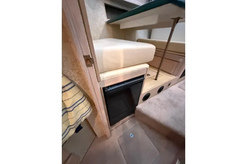  Yacht Photos Pics 1994 Tollycraft 45 Cockpit Motor Yacht interior with compact fridge and seating area.