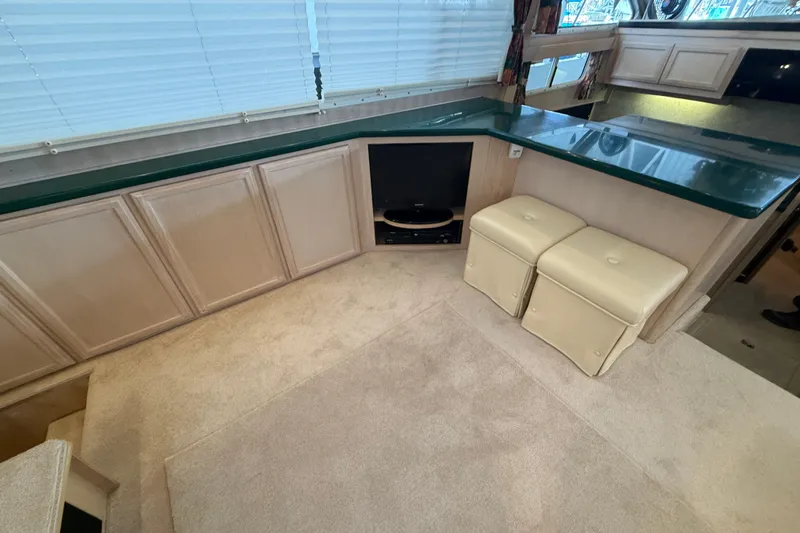  Yacht Photos Pics 1994 Tollycraft 45 Cockpit Motor Yacht interior with beige cabinets and green countertop.