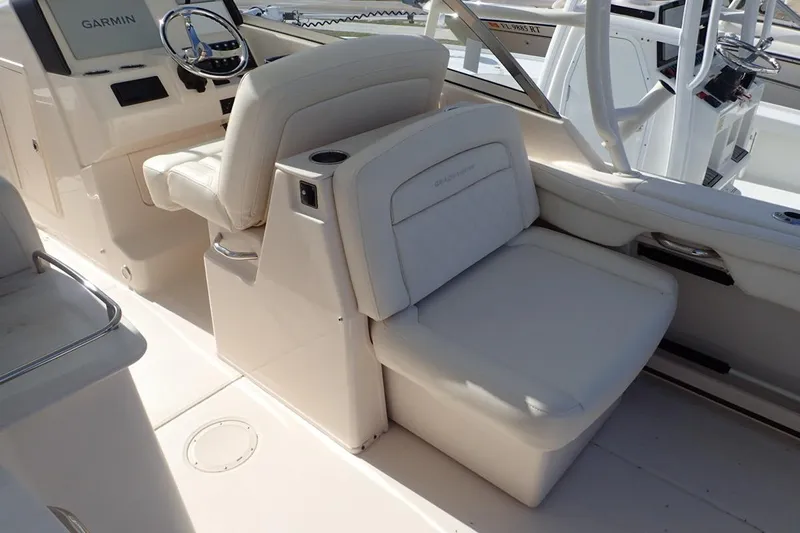  Yacht Photos Pics 2021 Grady-White Freedom 285 boat interior with Garmin navigation system and comfortable seating.