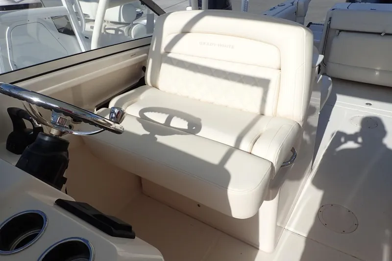  Yacht Photos Pics 2021 Grady-White Freedom 285 boat interior with steering wheel and cushioned seating.