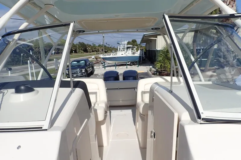  Yacht Photos Pics 2021 Grady-White Freedom 285 boat interior with open windshield and seating area.