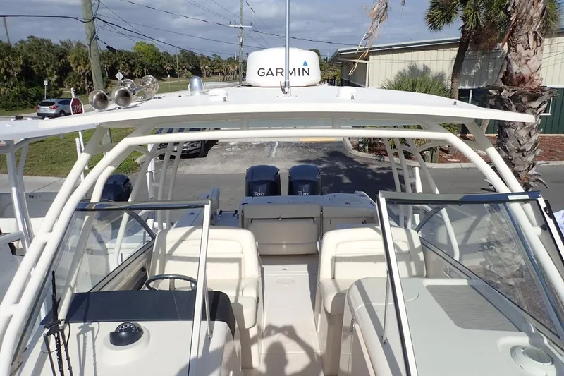  Yacht Photos Pics 2021 Grady-White Freedom 285 boat with Garmin equipment, parked near palm trees.