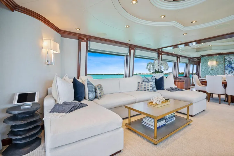 Risk And Reward Yacht Photos Pics Luxurious Crescent Raised Pilothouse yacht interior, 2004 model, featuring elegant seating and ocean views.