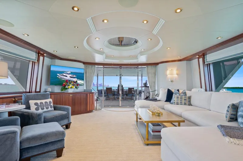 Risk And Reward Yacht Photos Pics Luxurious Crescent Raised Pilothouse yacht interior, 2004 model, featuring elegant seating and ocean views.
