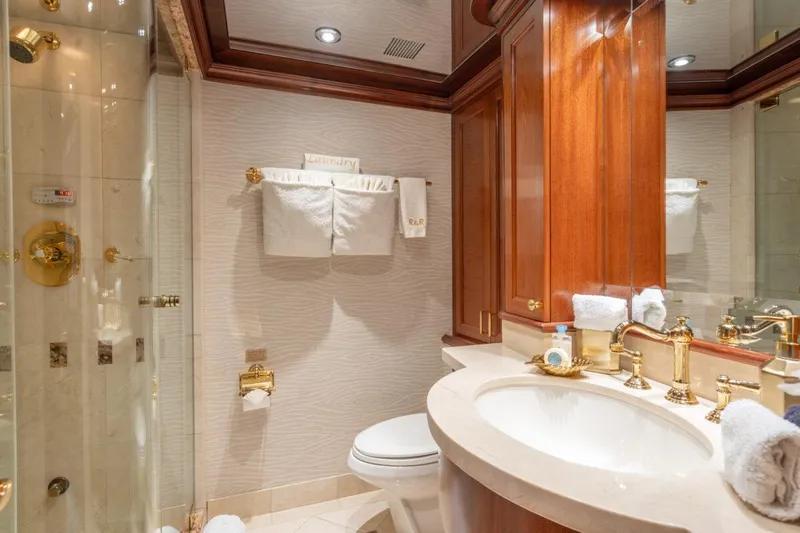 Risk And Reward Yacht Photos Pics Luxurious bathroom in 2004 Crescent Raised Pilothouse yacht with elegant fixtures and wood accents.