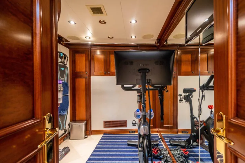 Risk And Reward Yacht Photos Pics Luxurious yacht gym with exercise bike, wooden paneling, and mirrored walls on Crescent Raised Pilothouse 2004.