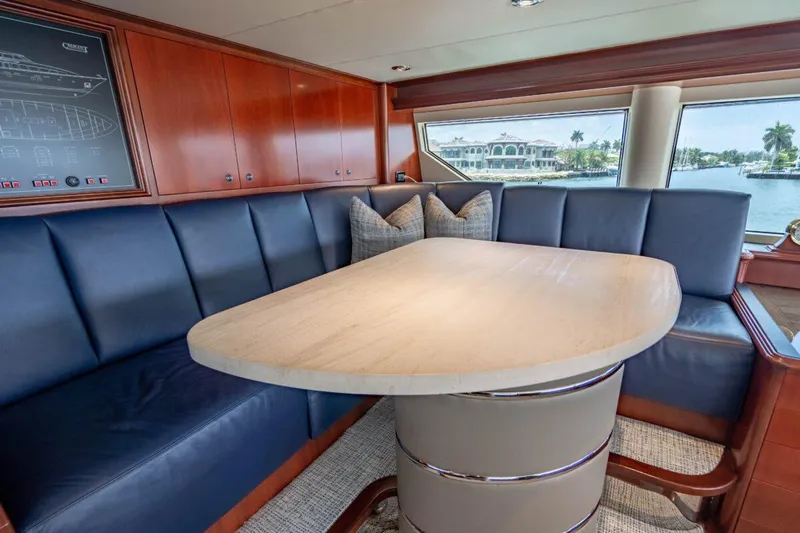 Risk And Reward Yacht Photos Pics Luxurious Crescent Raised Pilothouse 2004 yacht interior with elegant dining area and waterfront view.