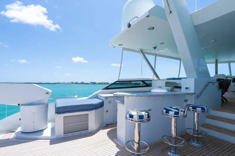 Risk And Reward Yacht Photos Pics Luxurious 2004 Crescent Raised Pilothouse yacht deck with bar stools and ocean view.