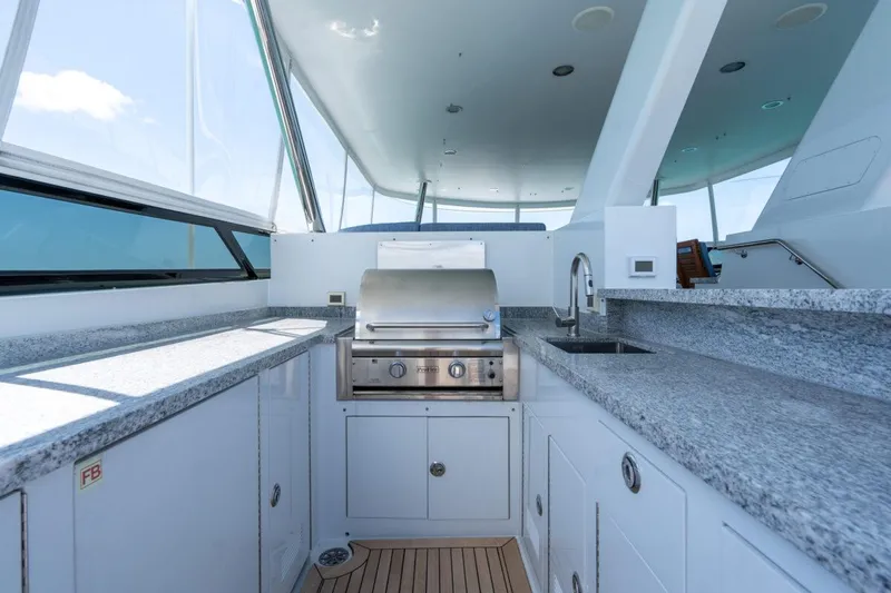 Risk And Reward Yacht Photos Pics Luxurious 2004 Crescent Raised Pilothouse yacht kitchen with grill and granite countertops.