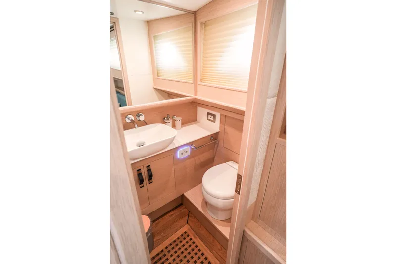 Viviendo Yacht Photos Pics Modern bathroom interior in 2024 Lancia Aprea 52 yacht, featuring sleek design and wooden accents.