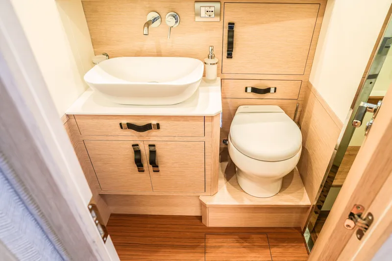 Viviendo Yacht Photos Pics Modern bathroom interior in 2024 Lancia Aprea 52 yacht, featuring sleek sink and toilet design.