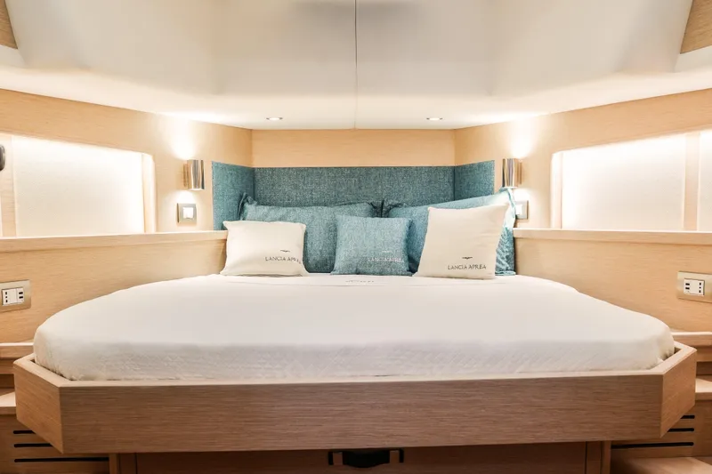 Viviendo Yacht Photos Pics Luxurious interior of 2024 Lancia Aprea 52 yacht with elegant bedding and ambient lighting.
