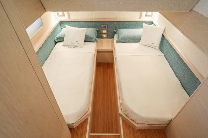 Viviendo Yacht Photos Pics 2024 Lancia Aprea 52 yacht interior with twin beds and elegant wood finish.