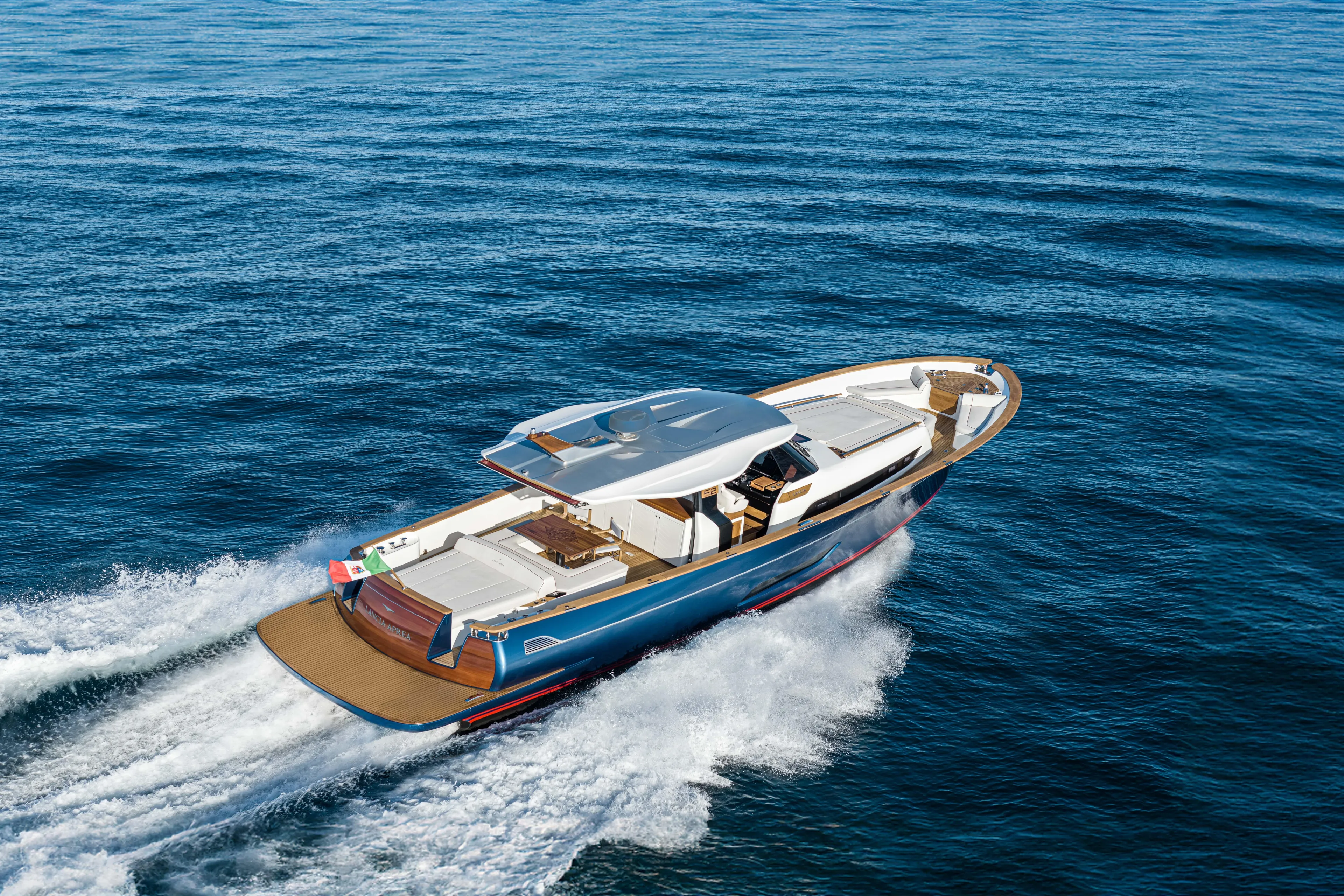 Viviendo Yacht Photos Pics 2024 Lancia Aprea 52 yacht cruising on open sea, showcasing sleek design and luxury features.