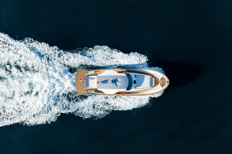 Viviendo Yacht Photos Pics Aerial view of 2024 Lancia Aprea 52 yacht cruising on open water.