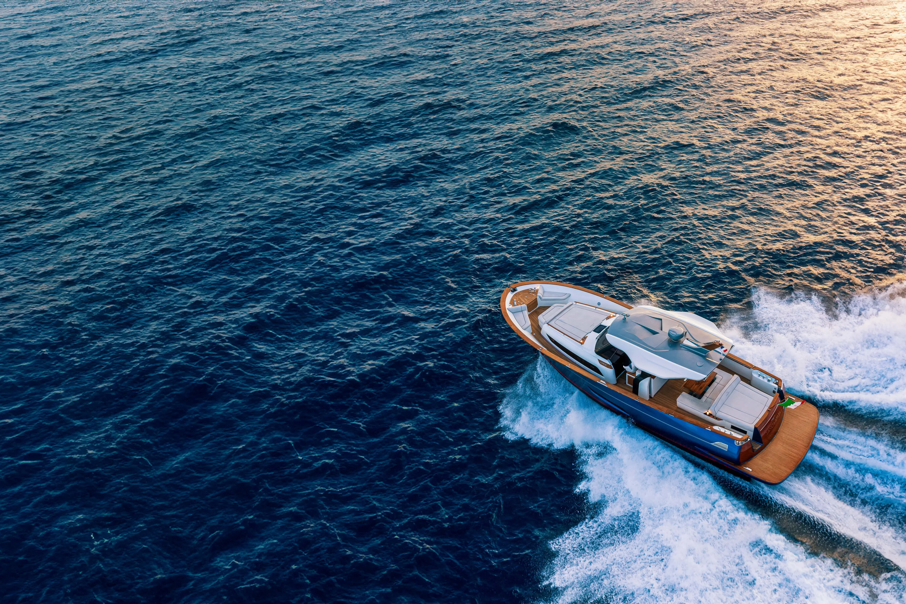 Viviendo Yacht Photos Pics 2024 Lancia Aprea 52 yacht cruising on open sea at sunset.