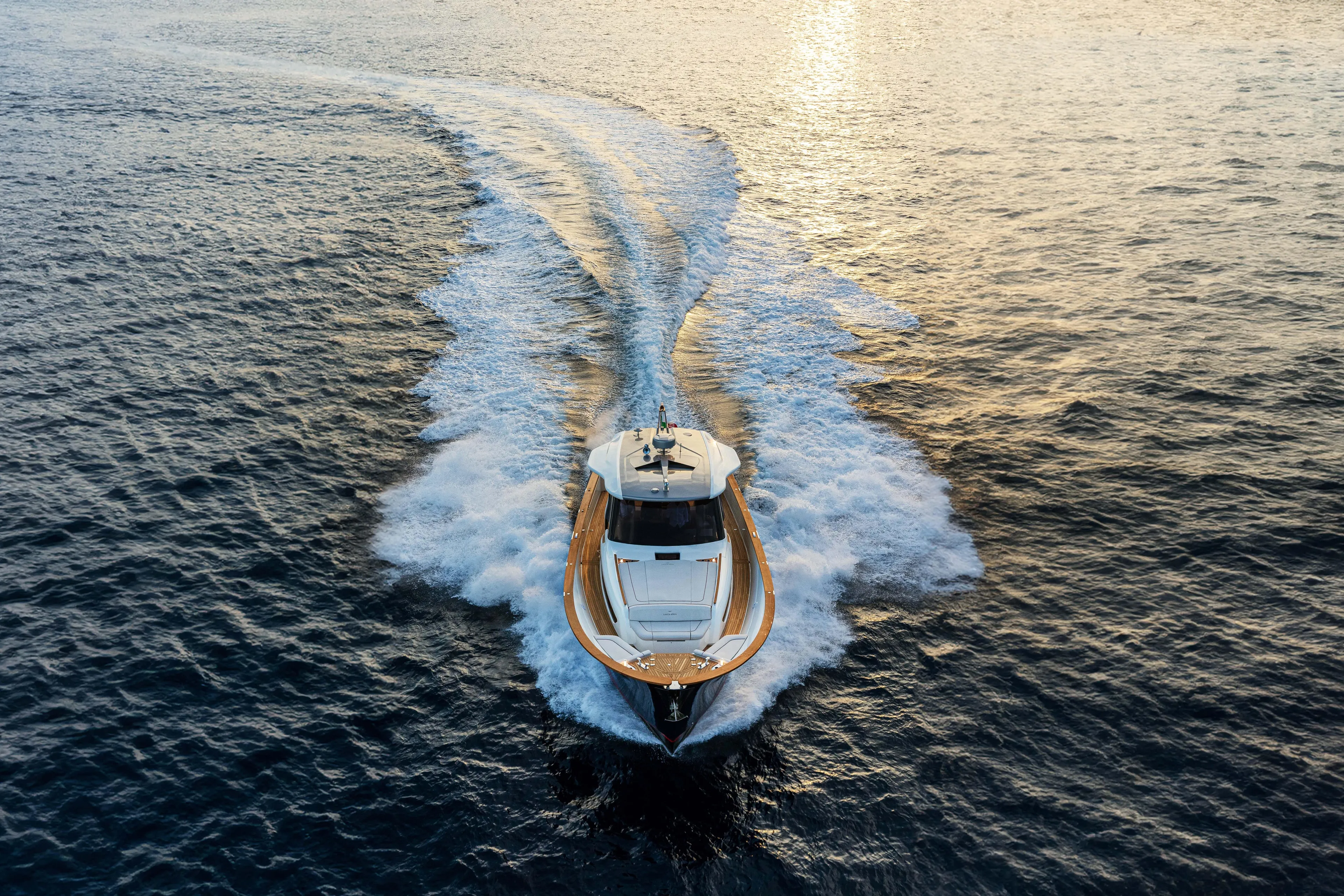 Viviendo Yacht Photos Pics 2024 Lancia Aprea 52 yacht cruising on open water at sunset.