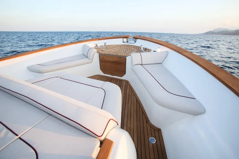 Viviendo Yacht Photos Pics Luxurious 2024 Lancia Aprea 52 yacht deck with elegant seating and ocean view.