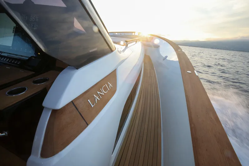 Viviendo Yacht Photos Pics 2024 Lancia Aprea 52 yacht cruising at sunset, showcasing sleek design and luxury.