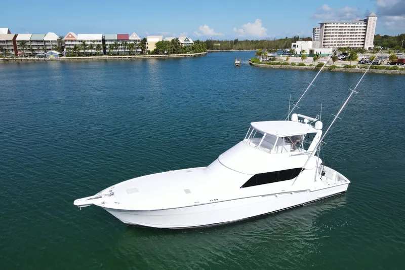 Glomar I Yacht Photos Pics 2004 Hatteras 60 Convertible yacht cruising in a scenic harbor setting.