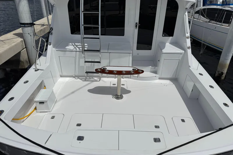 Glomar I Yacht Photos Pics 2004 Hatteras 60 Convertible yacht deck with ladder and seating area.