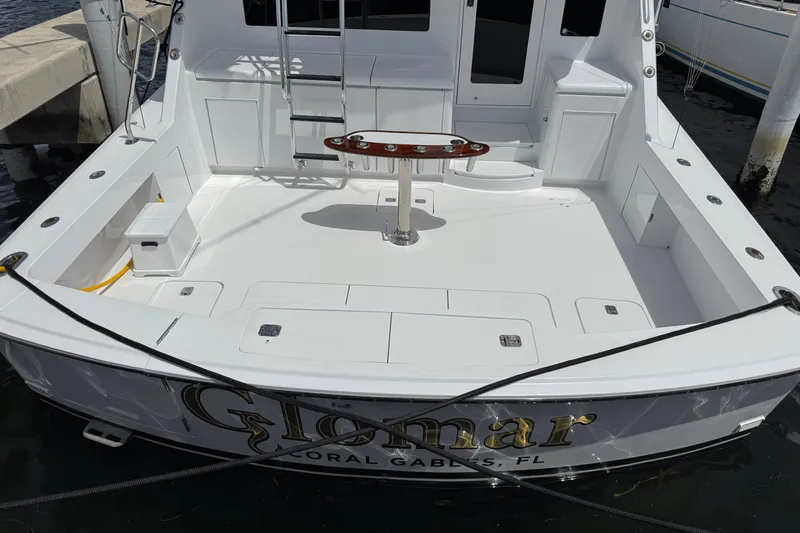 Glomar I Yacht Photos Pics 2004 Hatteras 60 Convertible yacht stern view, featuring spacious deck and fishing chair.