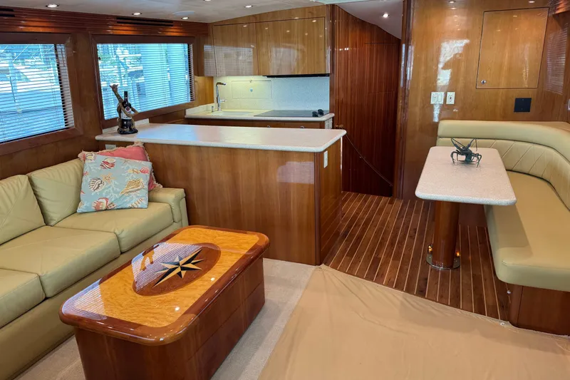 Glomar I Yacht Photos Pics Luxurious interior of 2004 Hatteras 60 Convertible yacht with elegant wood finishes.