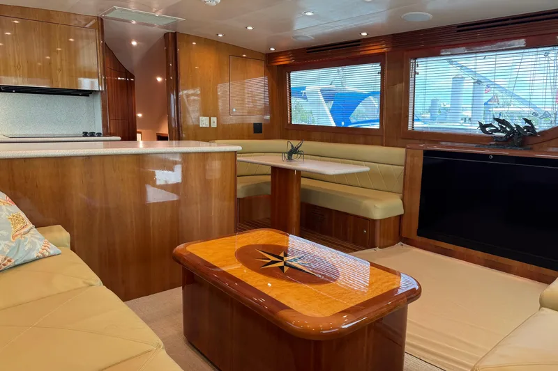 Glomar I Yacht Photos Pics Luxurious interior of 2004 Hatteras 60 Convertible yacht with wood finishes and comfortable seating.