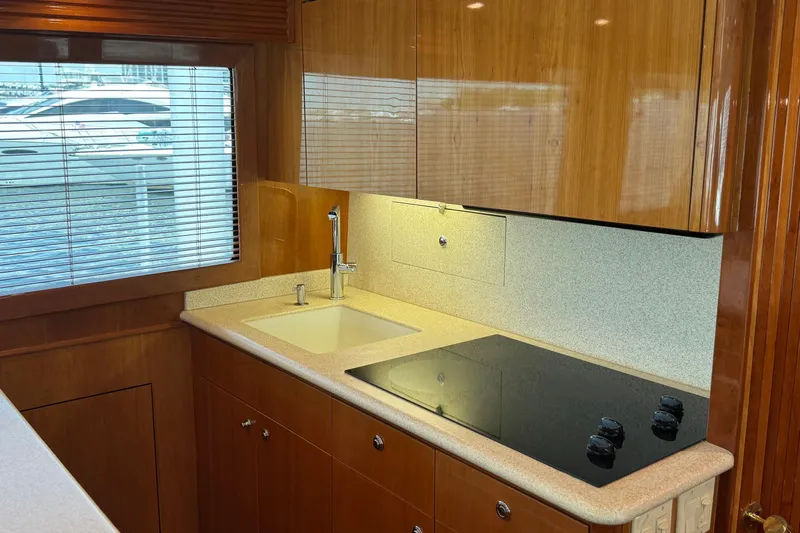 Glomar I Yacht Photos Pics 2004 Hatteras 60 Convertible yacht kitchen with modern sink and stovetop.