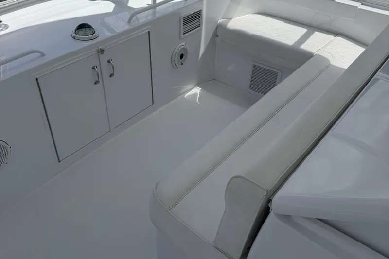 Glomar I Yacht Photos Pics 2004 Hatteras 60 Convertible yacht interior with white seating and storage cabinets.