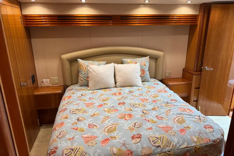 Glomar I Yacht Photos Pics Luxurious bedroom in 2004 Hatteras 60 Convertible yacht with seashell-themed bedding.